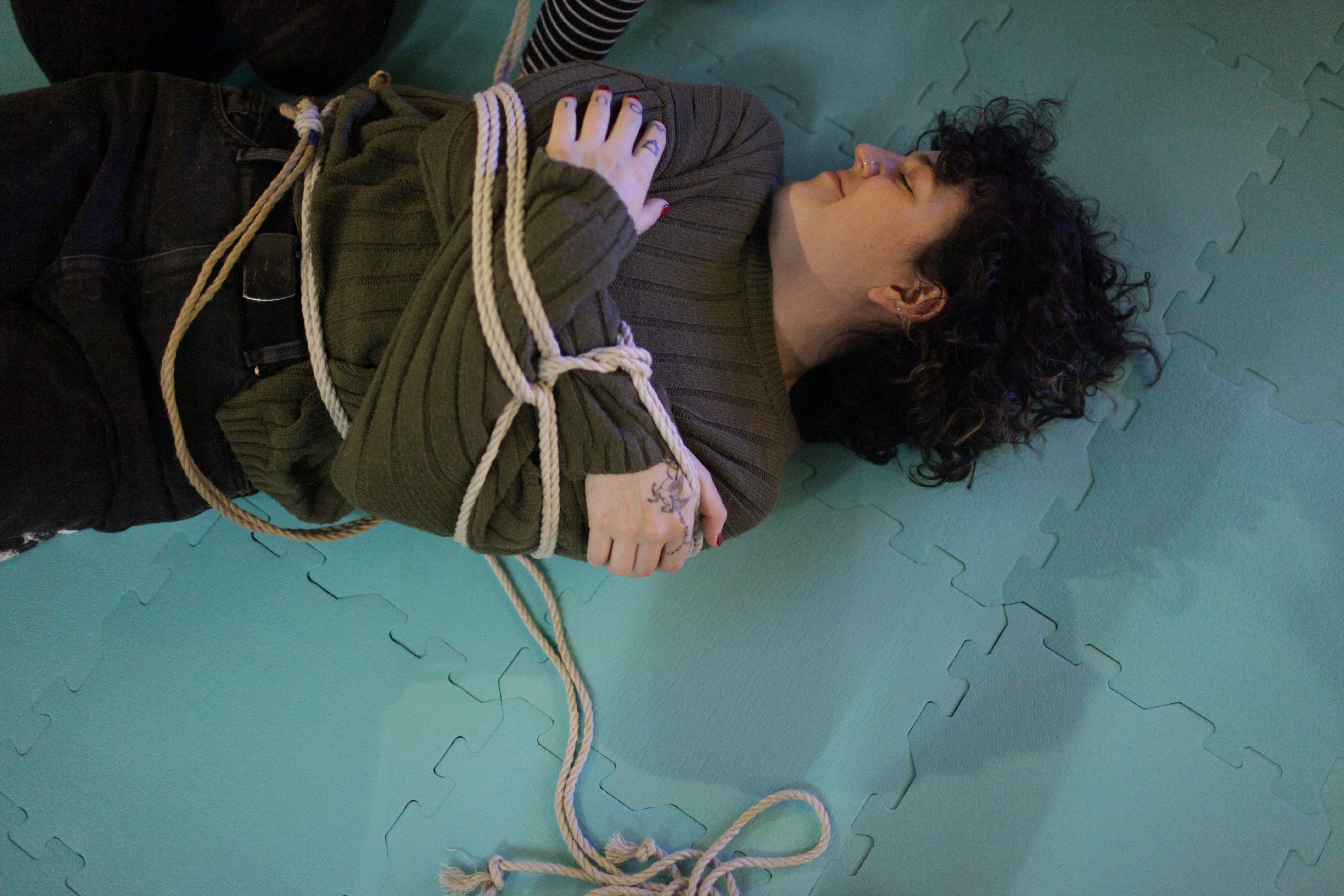 someone smiling being tied up on the ground